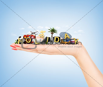 Travel concept. Hand holding atribute of travel and holiday.