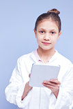 little scientist girl in a smock with a digital tablet