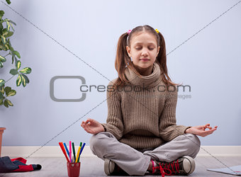 little girl meditating instead of making homework