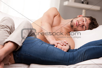 man and woman sprawling on a sofa and sleeping