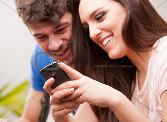 young woman and man with a mobile phone