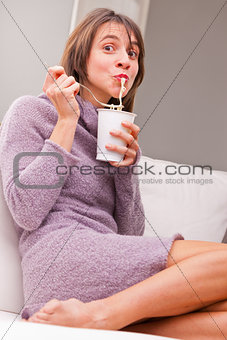 woman enjoying her noodles in relax