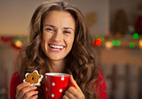 Portrait of happy young woman with cup of hot chocolate and chri
