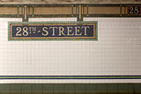 New York City Station subway 28th Street  sign on tile wall.