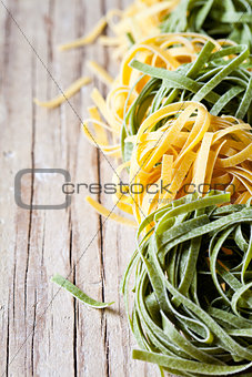yellow and green uncooked pasta tagliatelle 