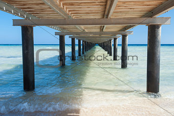 Wooden jetty on tropical beach