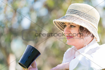 Woman  with cup of coffee  in nature