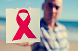 young man with a picture of a red ribbon for the fight against A