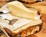 Parmesan cheese on a wooden plate