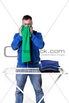 man smells laundry