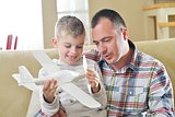 father and son assembling airplane toy