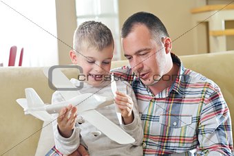 father and son assembling airplane toy