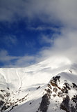 View on off-piste sunlight slope in clouds