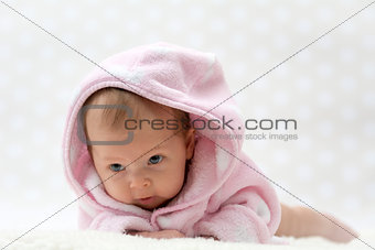 cute little baby girl in pink bathrobe