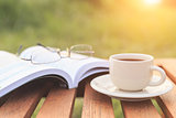 Close up Coffee cup and book on the table in the morning