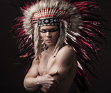 Indian strong man posing with traditional native american make up