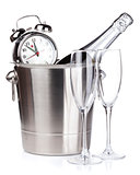 Christmas champagne with alarm clock in bucket and empty glasses