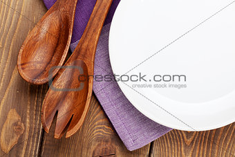 Wood kitchen utensils and empty plate