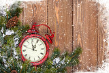 Christmas wooden background with clock and snow fir tree