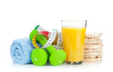 Two green dumbells, tape measure and healthy food