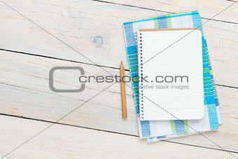 Notepad over kitchen towel on wooden table