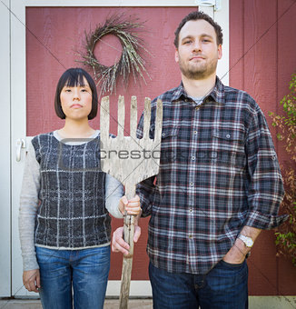 Fun Mixed Race Couple Portrait Simulating the American Gothic Pa