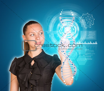 Beautiful young girl with big eyes smiling and presses finger on model of DNA