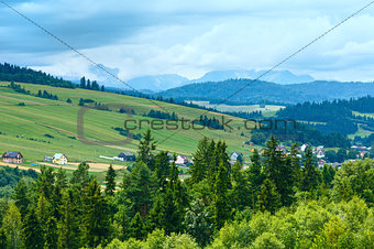 Summer cloudy mountain village view (Poland)