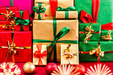 Three Piles of Xmas Gifts in Red, Gold and Green