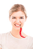 Woman with a silly face holding a red chilli pepper