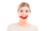 Woman with a silly face holding a red chilli pepper