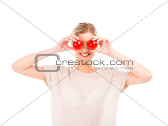 Beaitiful woman with tomatos in front of the face