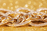 close up of gold chainlet. luxe golden glitter background