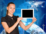 Beautiful businesswoman holding tablet pc with blank screen. Buildings and Earth as backdrop