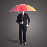 Businessman holding rainbow umbrella 