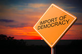 Import of Democracy on Warning Road Sign.