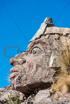 Inca face sculpture in the peruvian Andes at Puno Peru