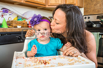 Woman Kisses Baby in Kitchen