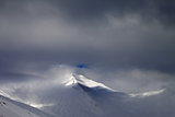 View on off-piste slope in storm clouds