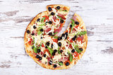 Pizza on white wooden background. 