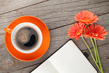 Blank notepad, coffee cup and orange gerbera flowers