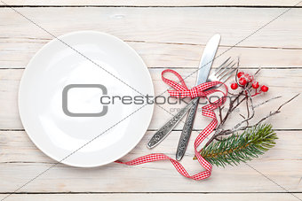 Empty plate, silverware and christmas decor