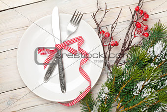 Silverware on plate and christmas tree decor