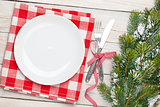 Empty plate, silverware and christmas tree