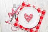 Valentines day heart shaped toy gift on plate with silverware