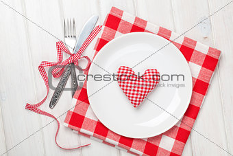 Valentines day heart shaped toy gift on plate with silverware