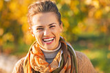 Portrait of smiling young woman in autumn outdoors