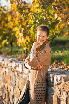 Portrait of happy young woman in autumn park