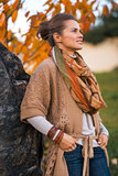 Portrait of young woman in autumn outdoors in evening