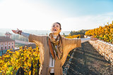 Happy young woman in autumn outdoors rejoicing